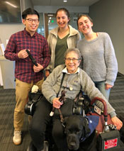 Team Buckle Up poses with Abby and her service dog, Nathan