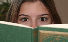 Woman reading a book with an intense gaze