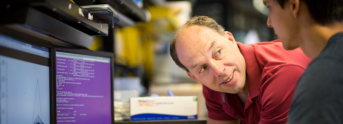 Professor Steven Quake with student in front of a computer 