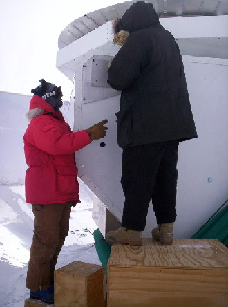 QUaD team members work on the telescope. Picture credit John Kovac