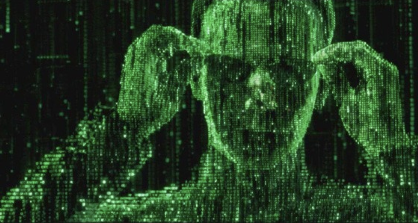 An image similar to a part of the Matrix movie, with text cascading down the screen making the likeness of Neo, the main character