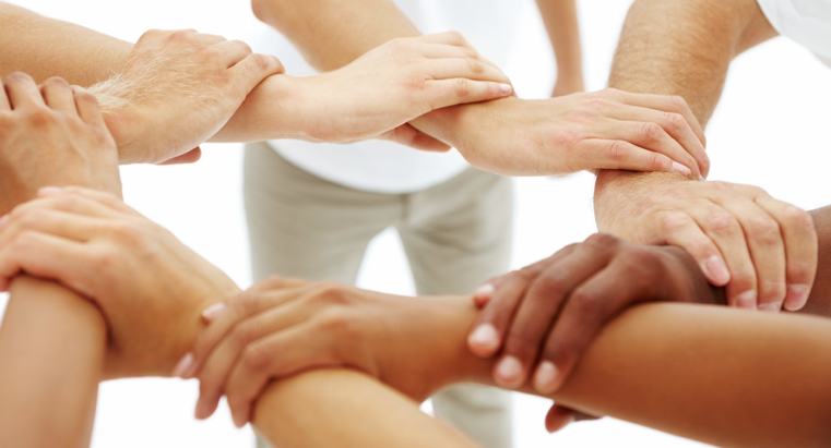 An image of a people with their wrists linked together