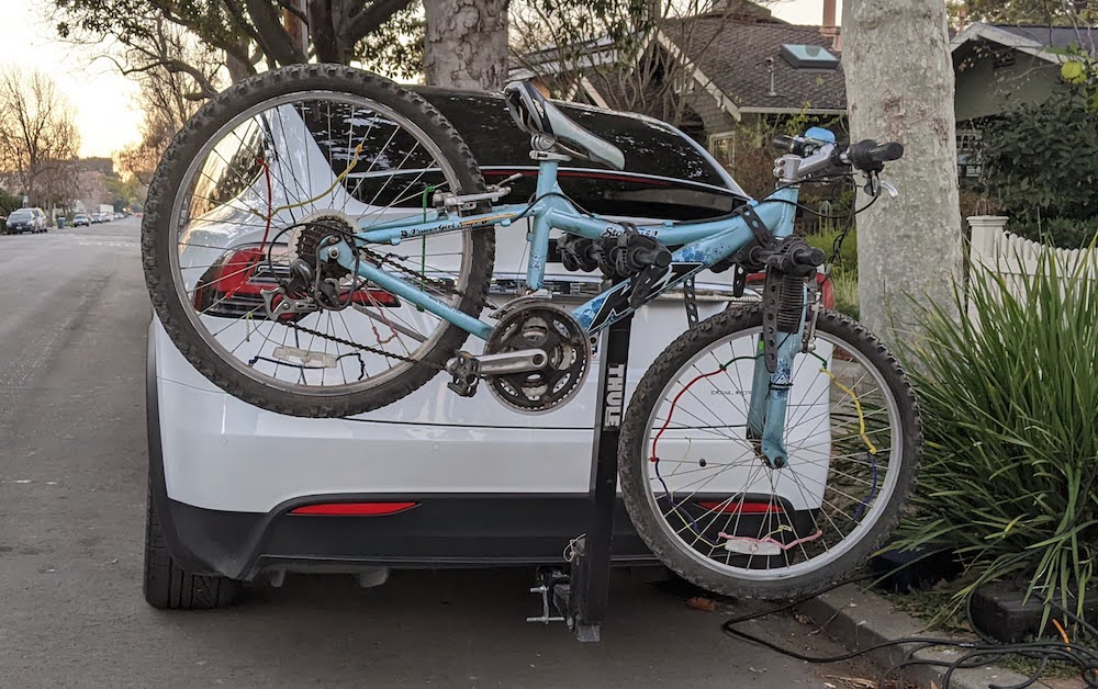 alt: bike attached to back of car